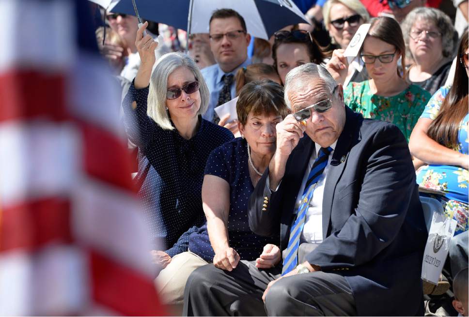 Scott Sommerdorf | The Salt Lake Tribune
Marjorie, center, and Ron Ellsworth, right, the parents of Trooper Eric Ellsworth react as they listen to the singing of "I Was Here" during the annual Utah Law Enforcement Memorial, Thursday, May 4, 2017.