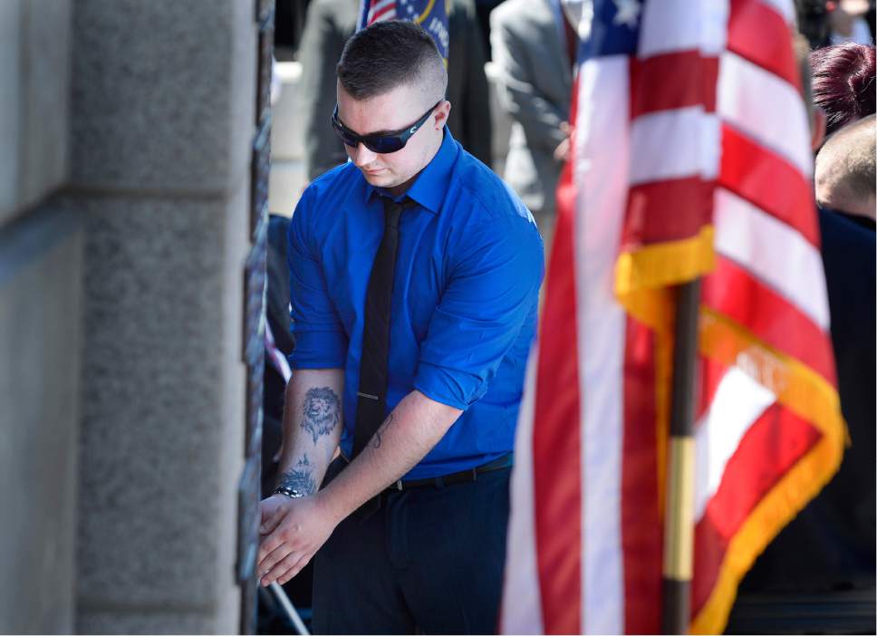 Scott Sommerdorf | The Salt Lake Tribune
Bradon Brotherson, affixes the plaque bearing his brother Cody's name to the Memorial Wall during the annual Utah Law Enforcement Memorial ceremony, Thursday, May 4, 2017. Officer Cody Brotherson was one of three officers enshrined during the ceremony.