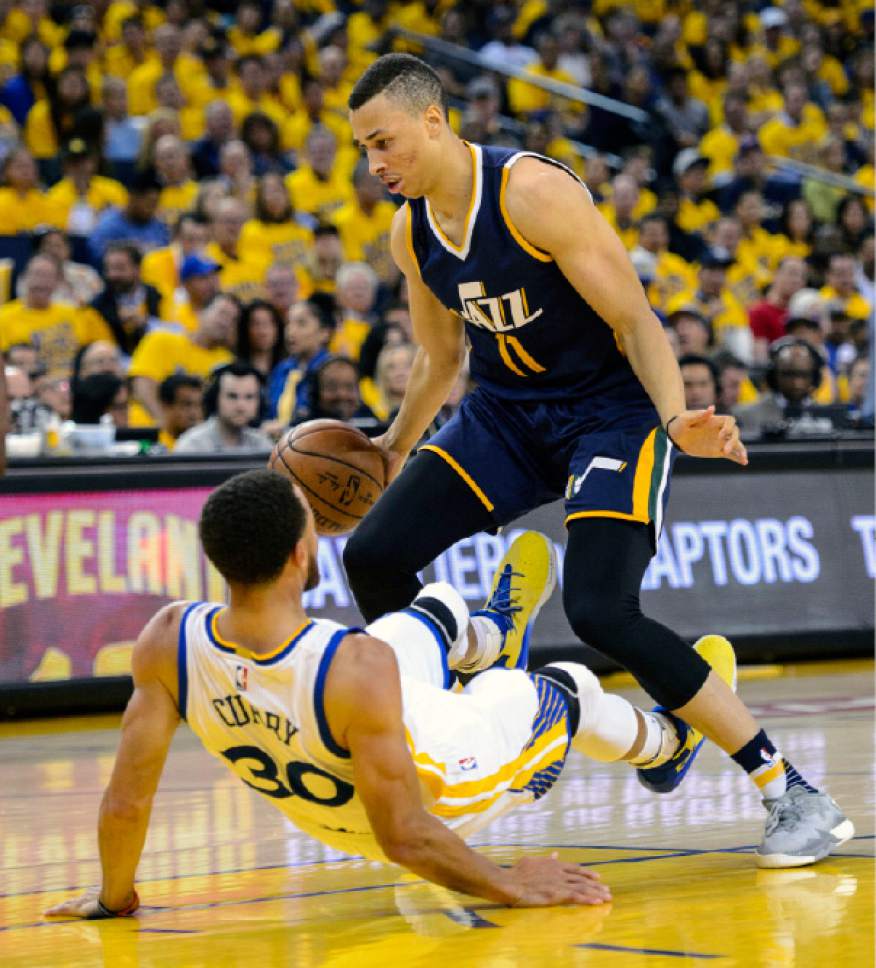 Steve Griffin  |  The Salt Lake Tribune


Utah Jazz guard Dante Exum (11) draws a charging foul as he knocks down Golden State Warriors guard Stephen Curry (30) during game 2 of the NBA playoff game between the Utah Jazz and the Golden State Warriors at Oracle Arena in Oakland Thursday May 4, 2017.