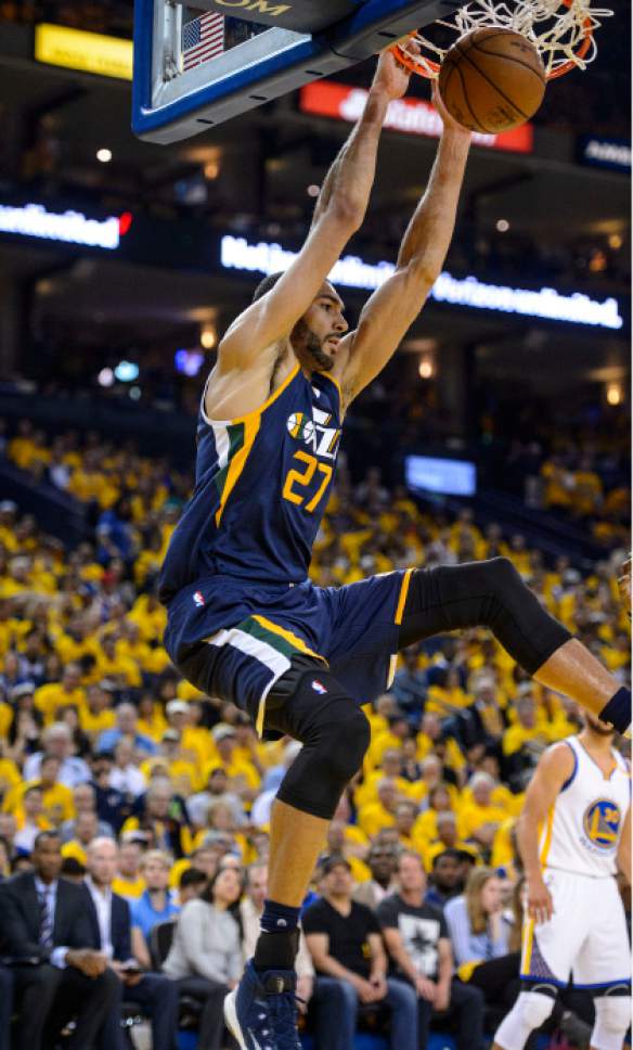 Steve Griffin  |  The Salt Lake Tribune


Utah Jazz center Rudy Gobert (27) hangs on the rim after slamming the ball during game 2 of the NBA playoff game between the Utah Jazz and the Golden State Warriors at Oracle Arena in Oakland Thursday May 4, 2017.