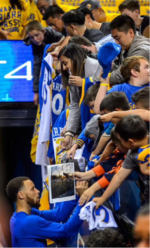Steve Griffin  |  The Salt Lake Tribune


Fans hang over the railing as Golden State Warriors guard Stephen Curry (30) signs autographs before game 2 of the NBA playoff game between the Utah Jazz and the Golden State Warriors at Oracle Arena in Oakland Thursday May 4, 2017.