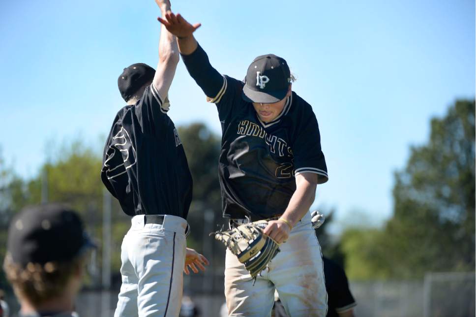 Scott Sommerdorf | The Salt Lake Tribune
Lone Peak's Alec Barney, left, and 3B Tom Bateman celebrate after a strikeout to end an inning. Lone Peak beat American Fork 5-3, Friday, May 5, 2017.