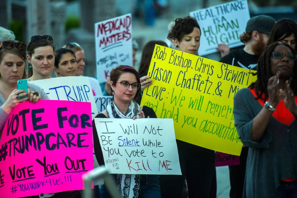 Chris Detrick  |  The Salt Lake Tribune
Participants hold signs and listen during the Utah Hands Off Our Healthcare Rally at the Wallace F. Bennett Federal Building in Salt Lake City Thursday, May 4, 2017.