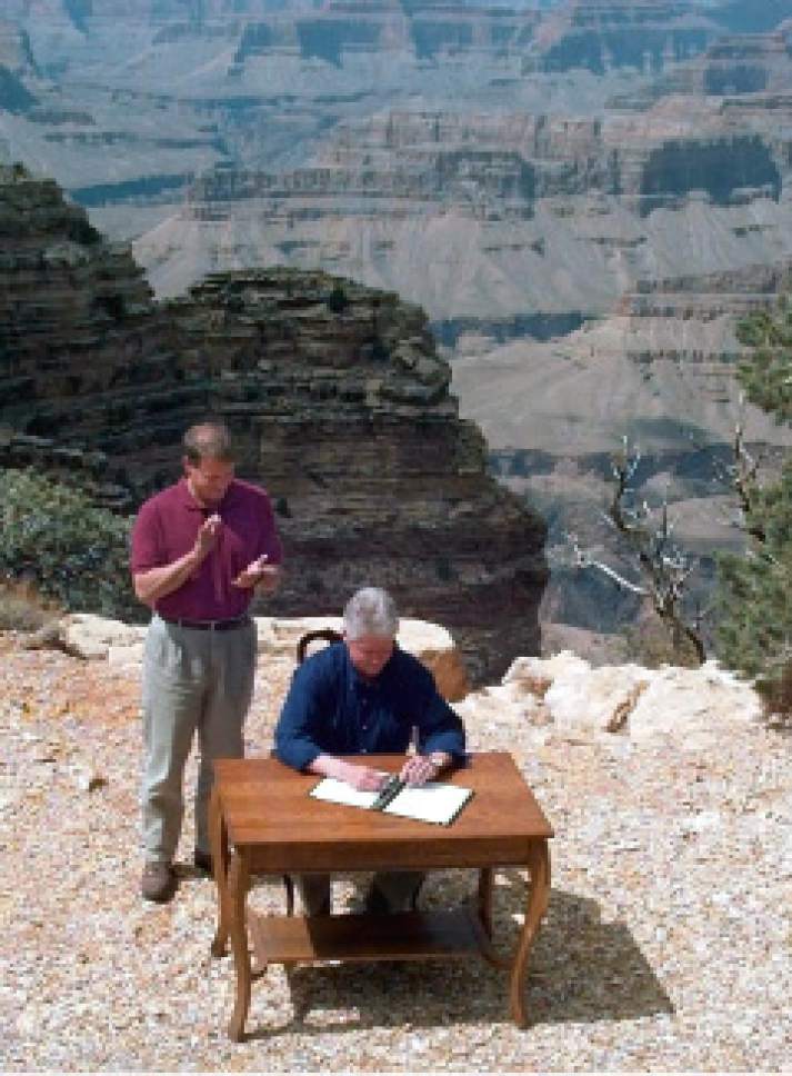 As Vice President Al Gore watches, President Clinton signs a bill declaring 1.7 million acres of southern Utah's red-rock cliff and canyons as Grand Staircase-Escalante National Monument. (AP Photo/Greg Gibson)