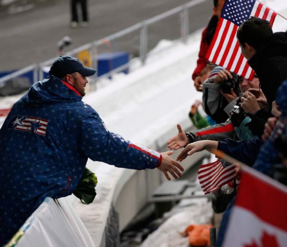 Trent Nelson  |  The Salt Lake Tribune
Steven Holcomb shakes fans' hands after his USA-1 sled won the gold medal in Four-Man Bobsled, XXI Olympic Winter Games, Saturday, February 27, 2010.
