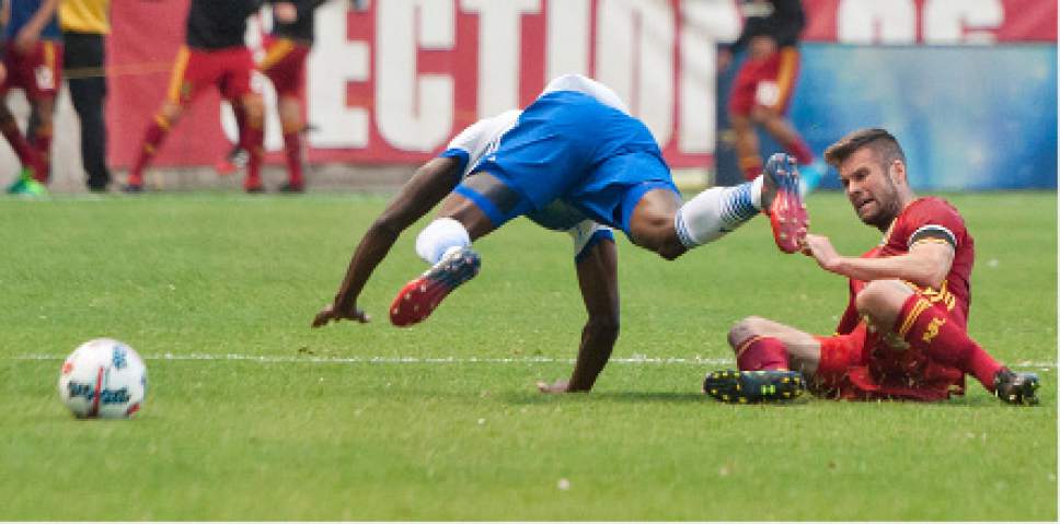 Michael Mangum  |  Special to the Tribune

FC Dallas midfielder Roland Lamah (20) falls to the pitch after a tackle from Real Salt Lake defender Chris Wingert (16) during their match at Rio Tinto Stadium in Sandy, UT on Saturday, May 6, 2017.