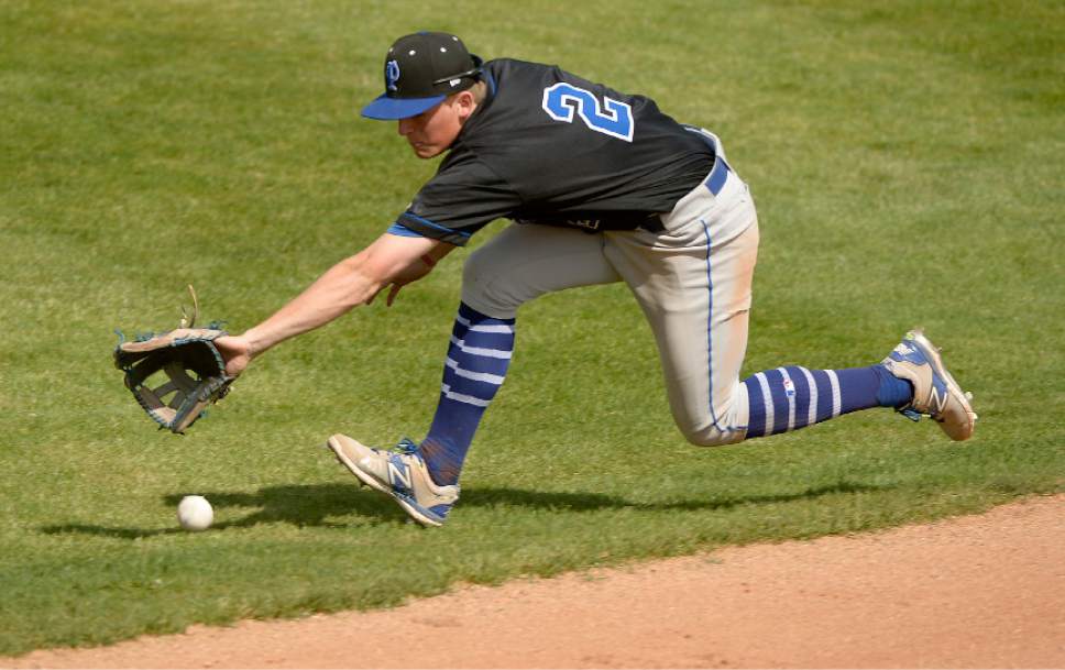 Leah Hogsten  |  The Salt Lake Tribune 
Pleasant Grove's Brock Watkins dives in the grass to make the catch. Lone Peak High School boys' baseball team defeated Pleasant Grove High School 8-5 during their game Monday, May 8, 2017.