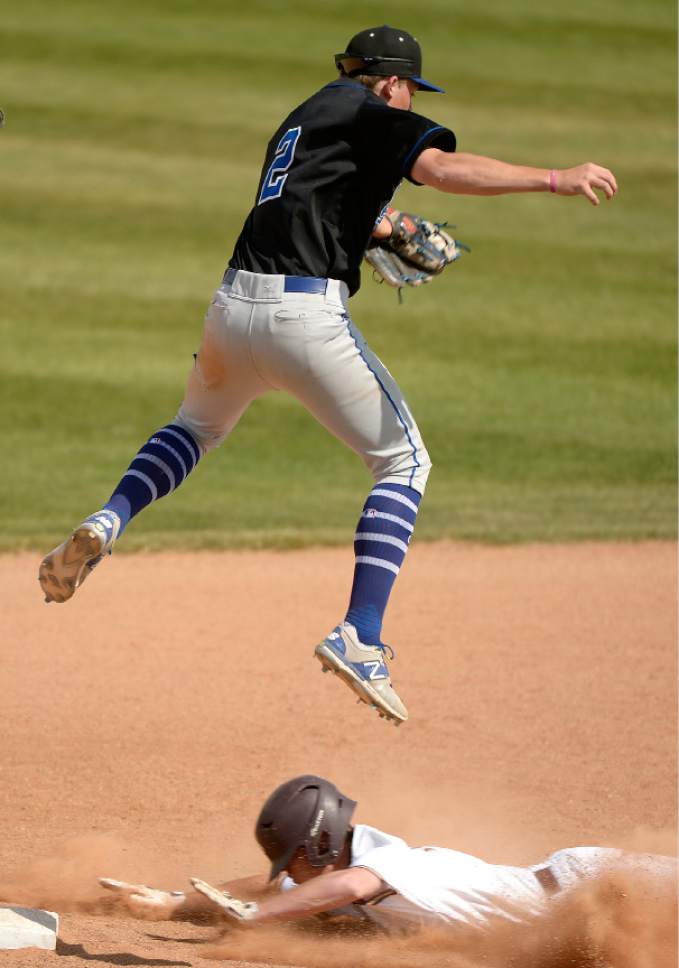 Leah Hogsten  |  The Salt Lake Tribune 
Pleasant Grove's Brock Watkins pulls down the catch but not in time to out Lone Peak's Tate Holmes at second. Lone Peak High School boys' baseball team defeated Pleasant Grove High School 8-5 during their game Monday, May 8, 2017.