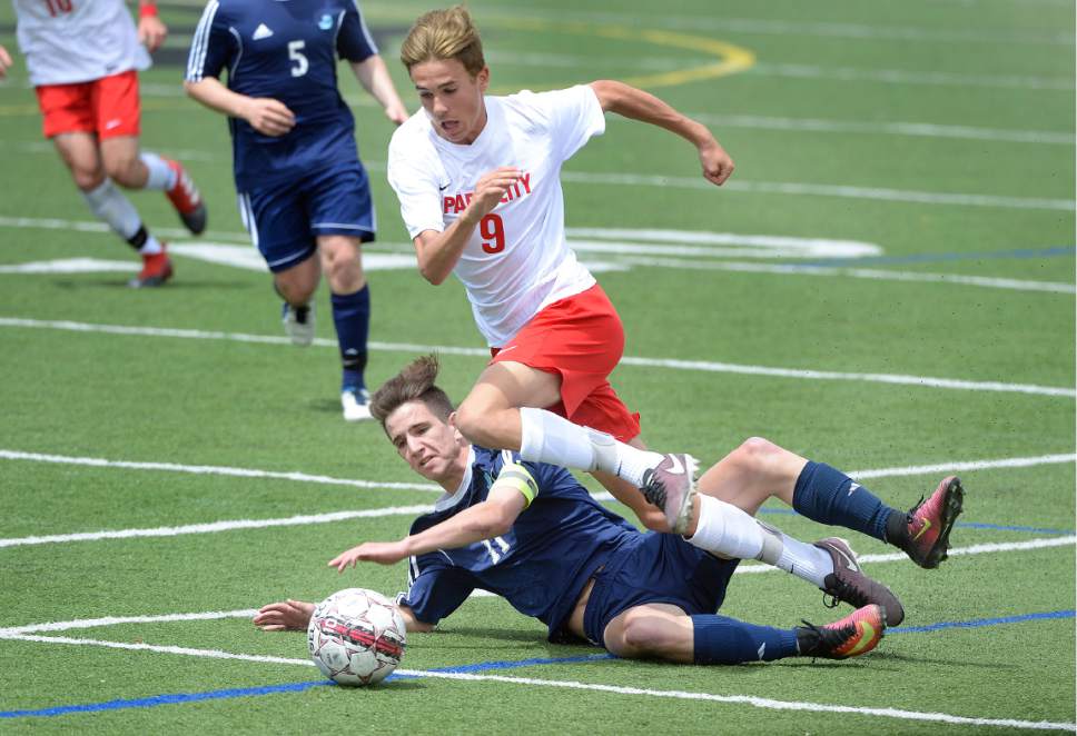 Scott Sommerdorf | The Salt Lake Tribune
Juan Diego's Evan Carlyle hits the turf as he and Park City's Max Dufner battle for control during second half play.  Juan Diego beat Park City 4-0 in a 3A boys' soccer state quarterfinal played in Park City, Saturday, May 6, 2017.