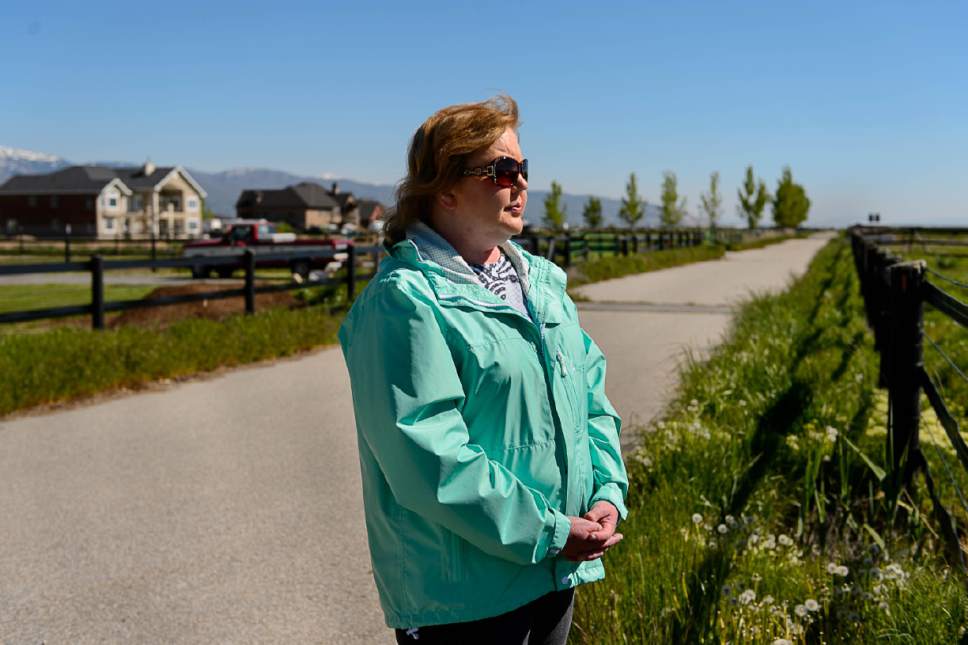 Trent Nelson  |  The Salt Lake Tribune
Christine Mikkelsen looks out into the quiet open space behind her Farmington home that may soon be occupied by the West Davis Corridor highway, Thursday May 4, 2017. Mikkelsen and her husband moved into their home six years ago when they were told they would never lose their view thanks to the Buffalo Ranch that would prevent development from blocking the sweeping vista of the Great Salt Lake and Antelope Island. Later, when they learned about the West Davis Corridor, a roughly 20-mile stretch of new freeway planned in northern Utah, with a $600 million-plus price tag, Mikkelsen became heavily involved in the Save Farmington group that has opposed the project. "Most people who bought out here bought for the view, for the quiet and for the country feel," Mikkelsen says. Now they will live with the noise and air pollution and a close up view of a freeway in their backyards and she says all state taxpayers will live with the bill of a very costly project.