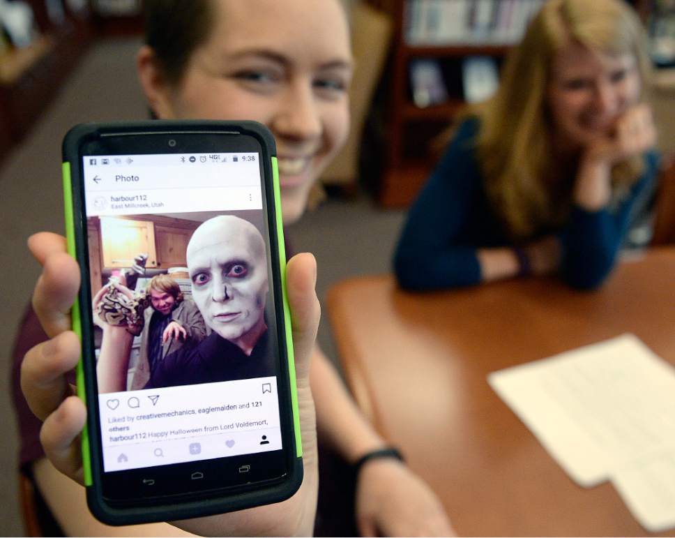 Al Hartmann  |  The Salt Lake Tribune
Marina Pimentel, shows a picture of her dressed as "Voldemort" for her first for chemotherapy appointment several months ago at Huntsman Cancer Institute.   She managed to keep her sense of humor through treatment of Hodkin's lymphoma.   Her patient navigator Sara Salmon, right. 
She couldn't navigate her world after her cancer diagnosis about a year ago.   Between her job, insurance, treatment and many other factors, she didn't know where to turn to get the right information to help her keep her life on track. She started working with Sara Salmon, adololescent-young adult patient navigator to get her through the process.