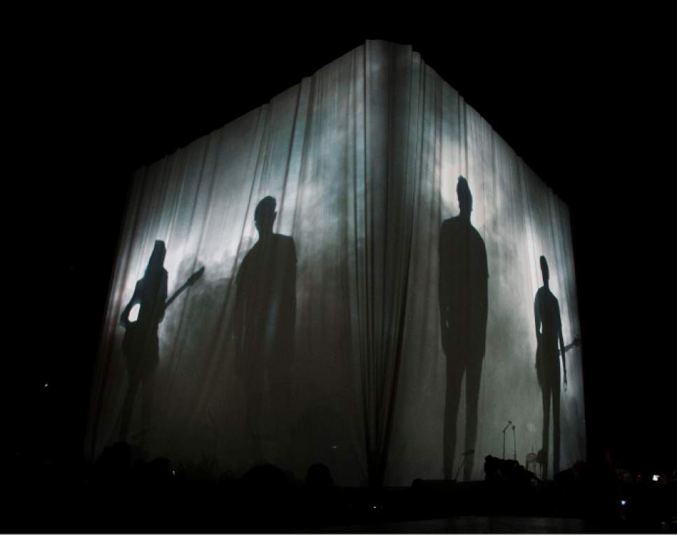 Steve Griffin  |  The Salt Lake Tribune


Members of Imagine Dragons are projected onto a giant curtain as they take the stage during their "Smoke and Mirrors" tour at EnergySolutions Arena in Salt Lake City, Tuesday, July 28, 2015.