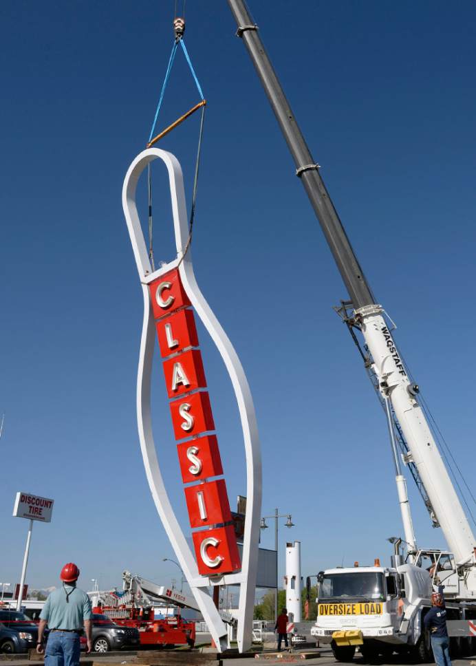 Al Hartmann  |  The Salt Lake Tribune
The 90-foot-tall iconic bowling pin sign rises again on State Street in South Salt Lake Tuesday May, 9. It was originally built in 1958 and was disassembled on April 12, 2017 for a complete renovation. Workers for Yesco Sign use a crane to ease it onto its base. It now will mark the entrance to the new Ritz Classic Apartments, under construction at 2265 S. State.