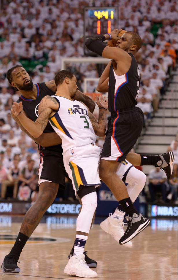 Leah Hogsten  |  The Salt Lake Tribune 
Utah Jazz guard George Hill (3) gets the foul on this play battling LA Clippers center DeAndre Jordan (6) and LA Clippers guard Chris Paul (3). The Utah Jazz lead the Los Angeles Clippers after the third quarter during Game 3 of their first-round Western Conference playoff series at Vivint Smart Home Arena, Friday, April 21, 2017.