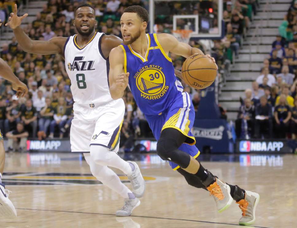 Golden State Warriors guard Stephen Curry (30) drives as Utah Jazz guard Shelvin Mack (8) defends in the first half during Game 4 of the NBA basketball second-round playoff series, Monday, May 8, 2017, in Salt Lake City. (AP Photo/Rick Bowmer)