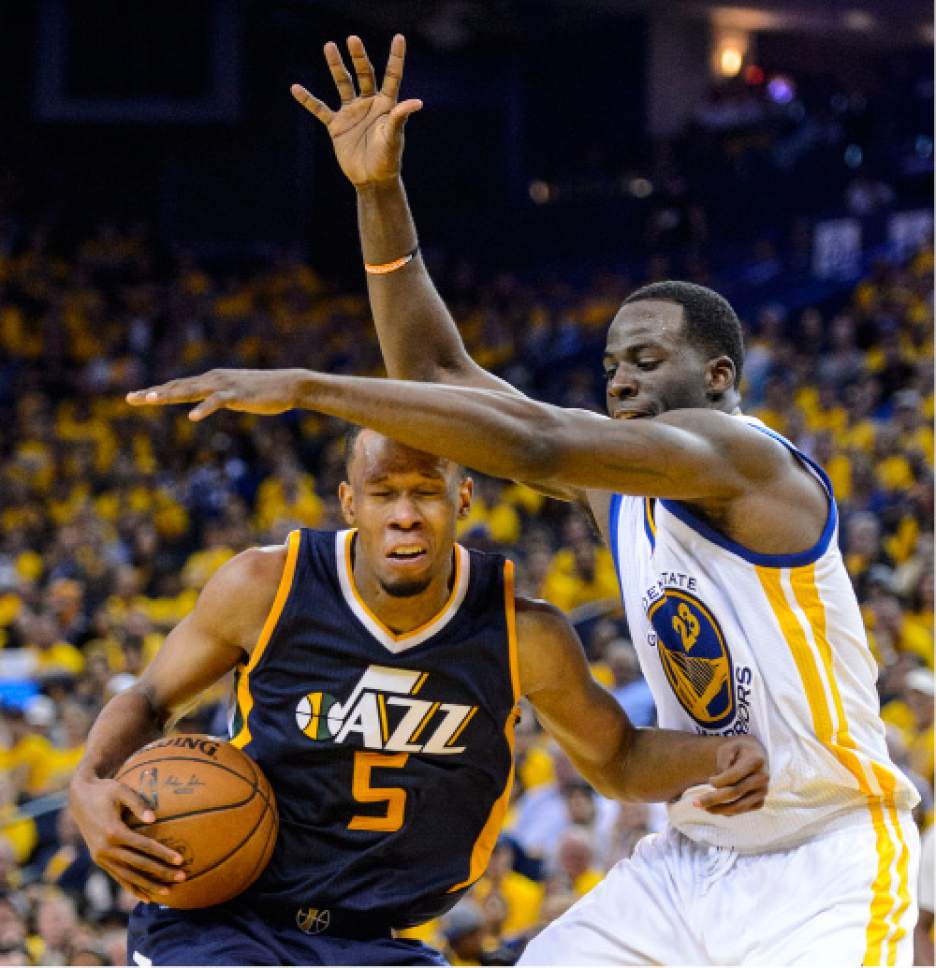 Steve Griffin  |  The Salt Lake Tribune


Utah Jazz guard Rodney Hood (5) gets smothered by the defense off Golden State Warriors forward Draymond Green (23) during game 2 of the NBA playoff game between the Utah Jazz and the Golden State Warriors at Oracle Arena in Oakland Thursday May 4, 2017.
