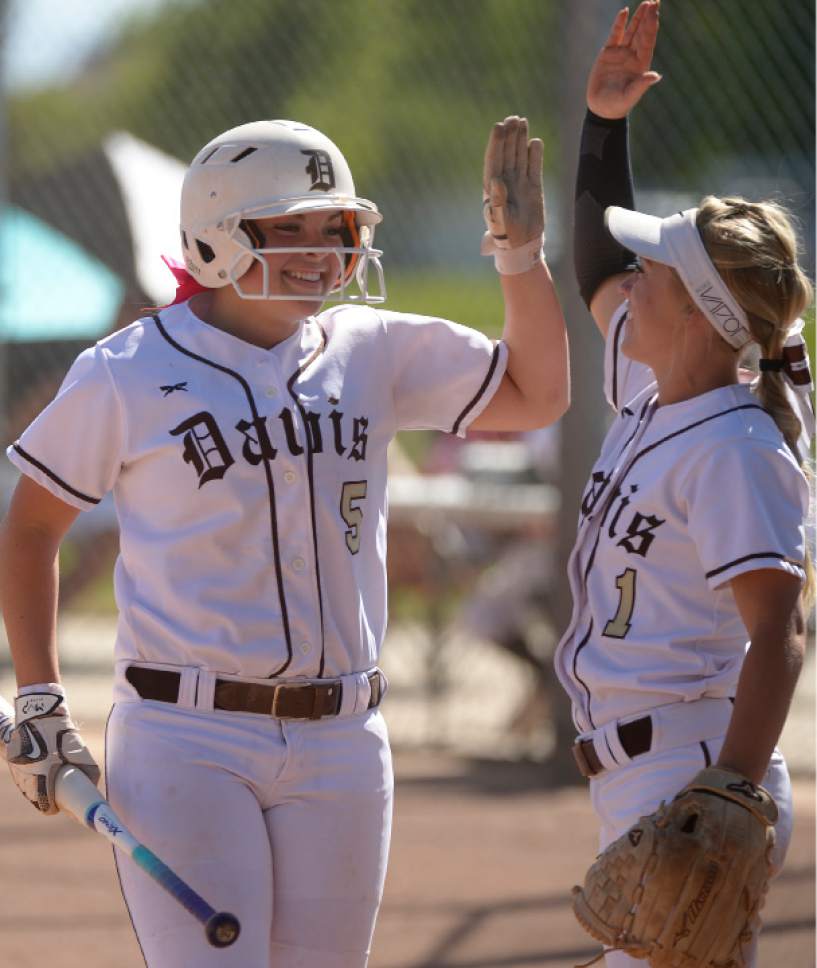 Leah Hogsten  |  The Salt Lake Tribune 
Davis' Paige Elkins celebrates her scoring run with teammate Paige Reynolds in the third inning. West High School girls' softball team defeated Davis High School, 13-8, in Kaysville, Thursday, May 11, 2017.