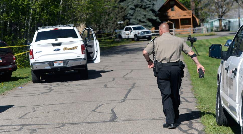 Al Hartmann  |  The Salt Lake Tribune
Weber County sheriff's deputies investigate a homicide at a residential home in the 7400 East block of 400 South in Huntsville Thursday.
