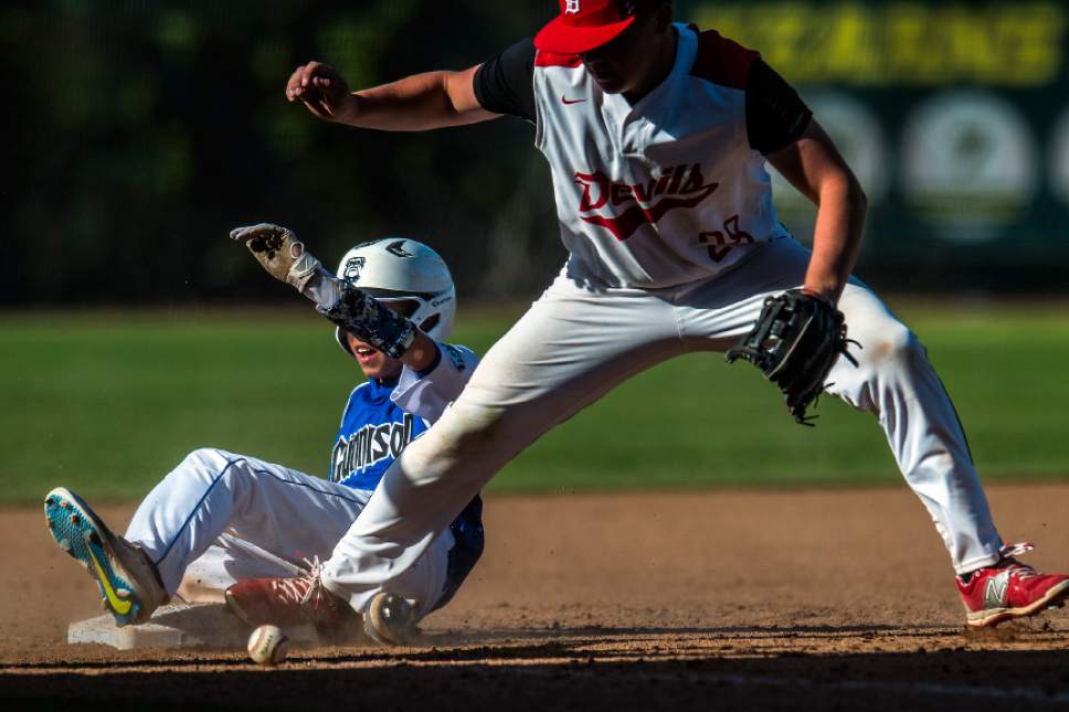 Chris Detrick  |  The Salt Lake Tribune
Gunnison Valley's Mason Bartholomew (14) slides safely into third base past Grand County's Christian Wilson (28)  during the Class 2A baseball state semifinal game at Kearns High School Friday, May 12, 2017.