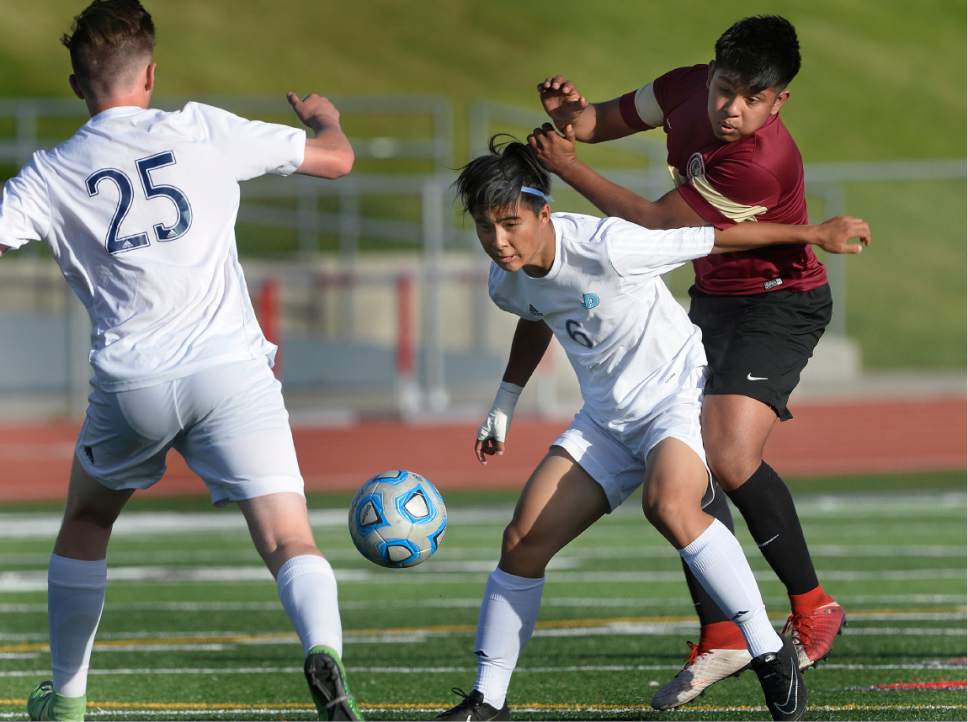 Scott Sommerdorf | The Salt Lake Tribune
Juan Diego's Taiki Hayashi protects the ball for team mate Brayden Reid during second half play. Juan Diego defeated Logan 3-1 in a 3A boy's semi-final, Friday, May 12, 2017.