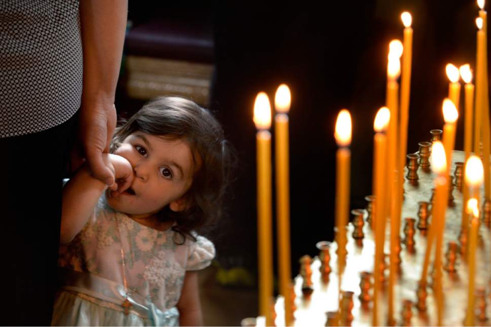 Scott Sommerdorf | The Salt Lake Tribune
A young girl carefully watches a visitor during worship service at Sts. Peter and Paul Orthodox Christian Church, Sunday, April 30, 2017.