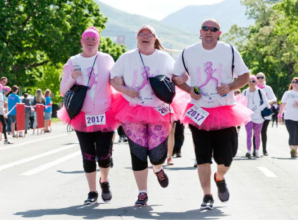 Michael Mangum  |  Special to The Tribune
Rachel Mackay, left, of Magna, Rebecca Anjewierden, and Steffan Mackay cross the finish line during the Susan G. Komen Race for the Cure in Salt Lake City on Saturday. It was the first Komen race for the trio, who say they plan to make it an annual event for their family as they run in support of Steffan Mackay's aunt and grandmother, who are cancer survivors.