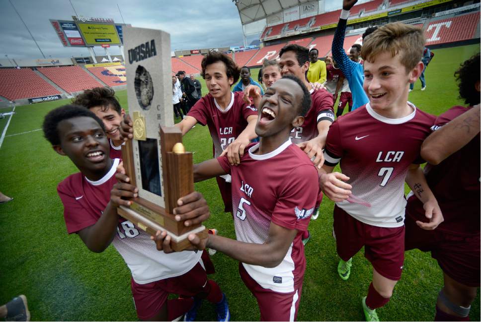 Scott Sommerdorf | The Salt Lake Tribune
Layton Christian Academy celebrates their 2A trophy after beating South Summit 1-0 to win the championship at Rio Tinto Stadium, Saturday, May 13, 2017.