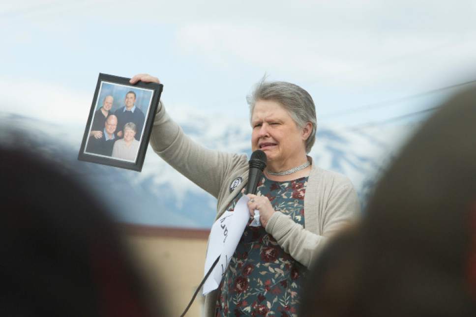 Briana Scroggins  |  Special to the Tribune
Annette Olsen, of Layton, tears up as she holds a photograph taken in 2015 of her, her husband, Rod, their son, Andy, and Nicolas Sanchez, who they considered a son, during a protest organized by Utah Against Police Brutality at the Roy Police Department on Saturday, May 13, 2017 in Roy. Sanchez was living with the Olsen family at the time of his death.
The protest is in response to an Roy Police officer involved shooting that lead to the death of Sanchez. A Roy Police officer got into a struggle with Sanchez, who was armed, on Feb. 21, 2017 at a gas station in Roy. Sanchez was shot multiple times by the two officers at the scene.
Sanchez was living with the Olsen family at the time of his death.