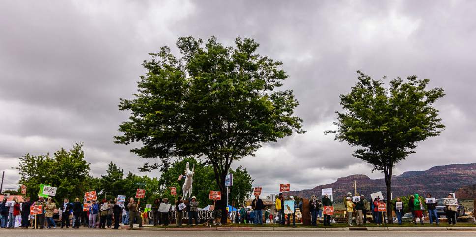 Trent Nelson  |  The Salt Lake Tribune
People hold signs up for passing cars at a Monument Rally and Business Owner's Press Conference in Kanab, Wednesday May 10, 2017. The event was planned to occur in conjunction with Interior Secretary Ryan Zinke's visit to Grand Staircase-Escalante National Monument.