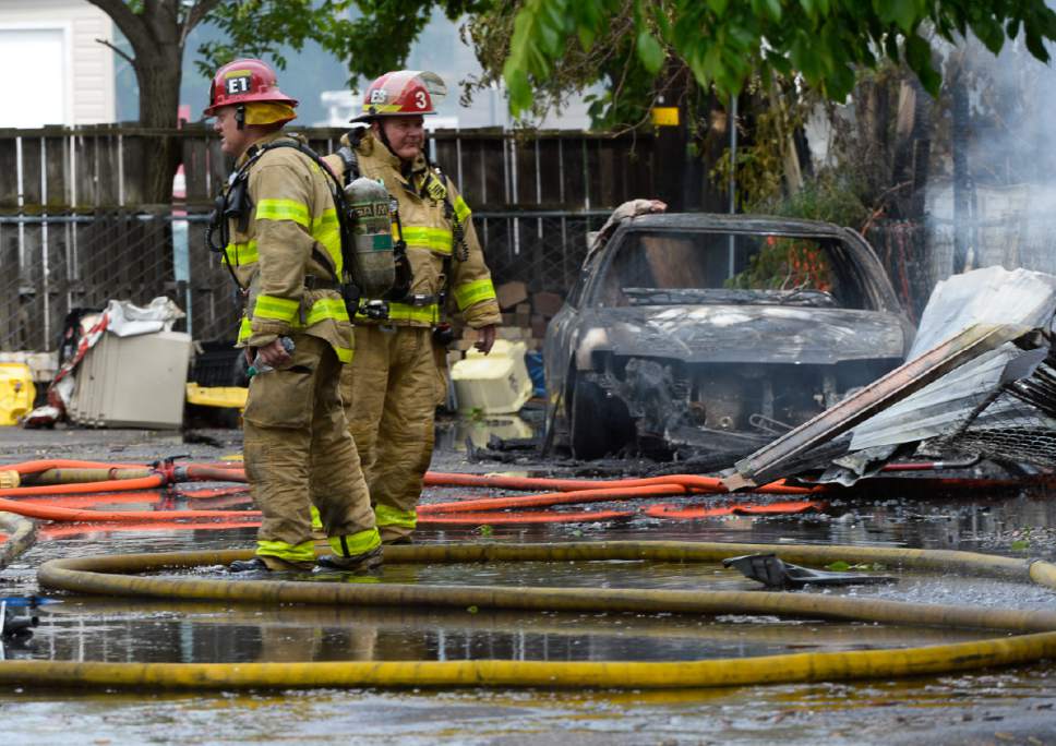 Francisco Kjolseth | The Salt Lake Tribune
Firefighters from across the city battle a two house fire at 900 W. 151 S. in Salt Lake City that sent smoke across the city on Monday, May 15, 2017.