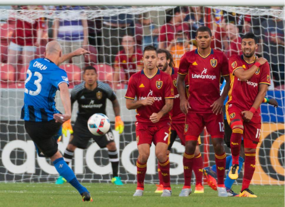 Michael Mangum  |  Special to the Tribune

Montreal Impact defender Laurent Ciman (23) takes a free kick toward the Real Salt Lake goal with Real Salt Lake forward Juan Manuel Martinez (7), forward Omar Holness (12), and midfielder Javier Morales (11) forming the wall during their MLS match at Rio Tinto Stadium in Sandy, UT on Saturday, July 9th, 2016.