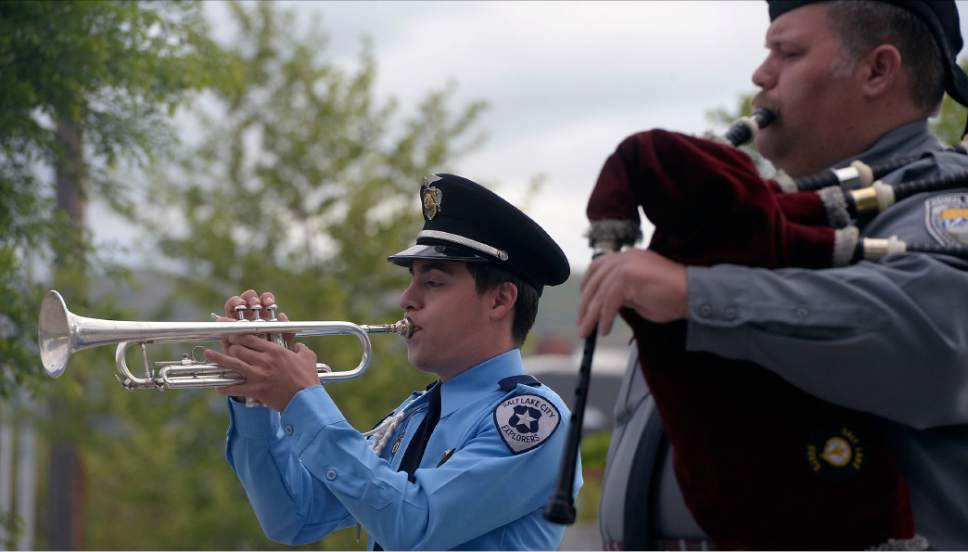 Al Hartmann  |  The Salt Lake Tribune
Salt Lake City Explorer Juan Vera plays taps and Ian Williams later played "Amazing Grace" on bagpipes at sunrise service Tuesday May 16 that honored and payed tribute to 25 Salt Lake City's fallen police officers over the years.
