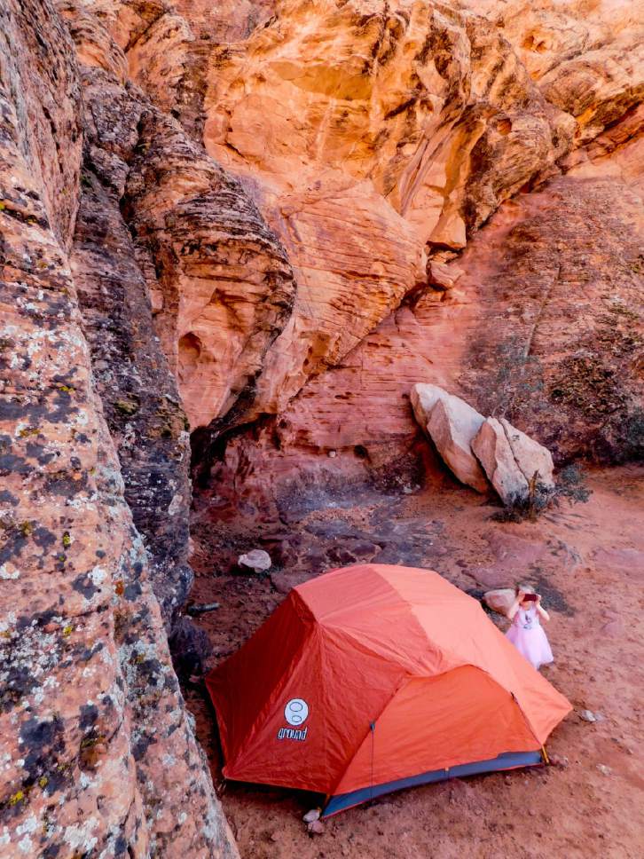 Erin Alberty  |  The Salt Lake Tribune 

A young camper takes pictures of the colorful sandstone that surrounds Sand Cove Primitive Campground on April 1, 2017 in the Red Cliffs Desert Reserve near Leeds.