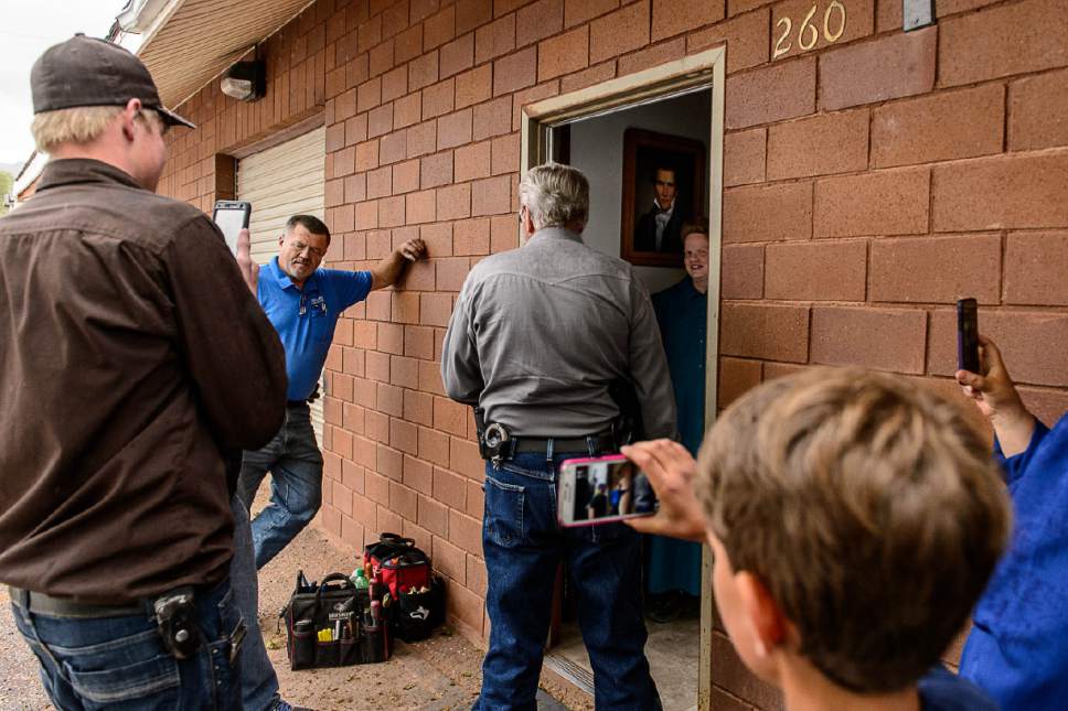 Trent Nelson  |  The Salt Lake Tribune
FLDS member Julia Johnson confronts Mohave County Constable Mike Hoggard, disputing the UEP Trust's ability to evict her from a property in Colorado City, AZ, Tuesday May 9, 2017. Locksmith Kelvin Holdaway in blue.