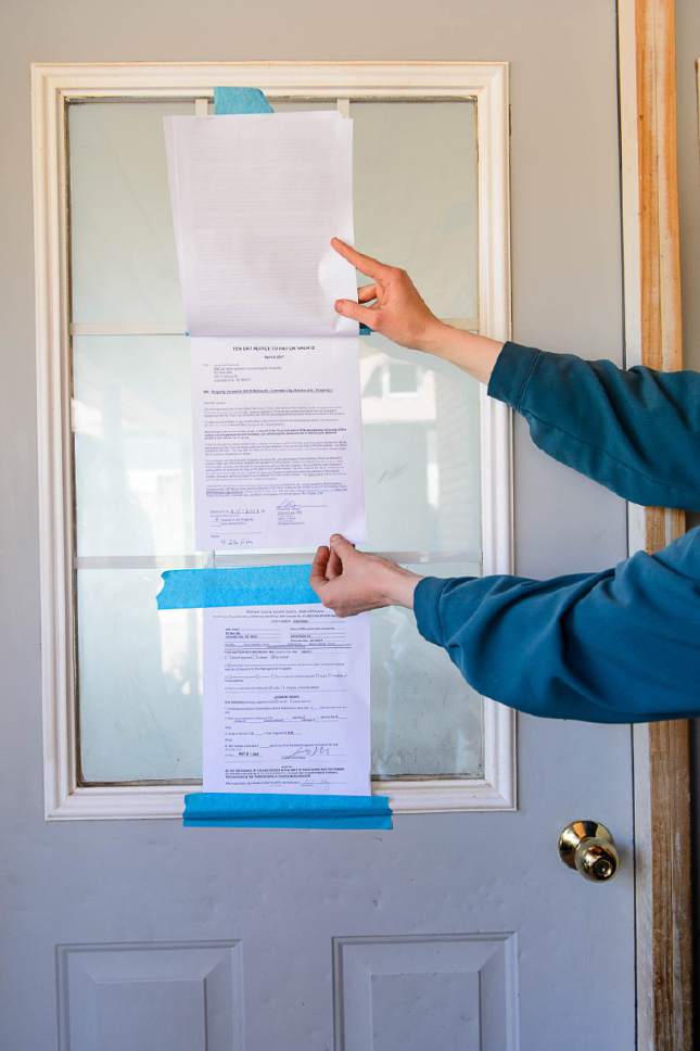 Trent Nelson  |  The Salt Lake Tribune
An FLDS woman looks at eviction notices on the Colorado City, AZ, home where she lives, Monday May 1, 2017.