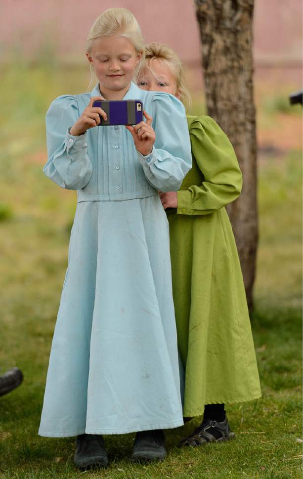 Trent Nelson  |  The Salt Lake Tribune
An FLDS girl takes video of the scene as her family is evicted from their Colorado City, AZ, home, Tuesday May 9, 2017.
