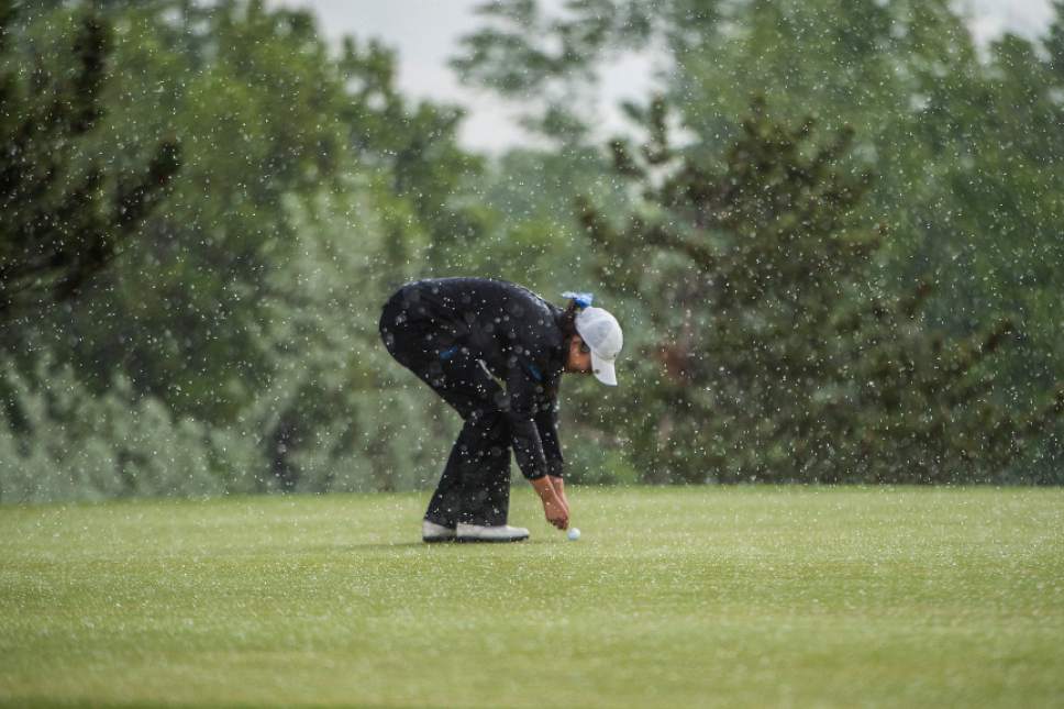 Chris Detrick  |  The Salt Lake Tribune
Bingham's Tess Blair marks her spot on the green during a rain delay during the Class 5A girls' golf state meet at Davis Park Golf Course Tuesday, May 16, 2017.