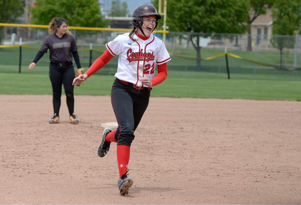 Scott Sommerdorf | The Salt Lake Tribune
Grantsville's Brayle Crosman yells as she approaches third base scoring ahead of Reannon Justice who hit a two-run home run in the sixth inning. Grantsville defeated Desert Hills 5-0 in a 3A state quarterfinal softball playoff game in Spanish Fork, Thursday, May 18, 2017.