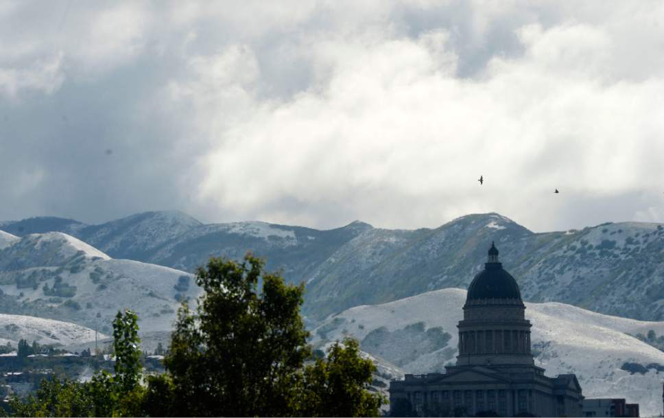 Al Hartmann  |  The Salt Lake Tribune
Clouds begin to break above the Utah State Capitol Wednesday morning after the foothills were coated with a light snow from last night's cold weather.