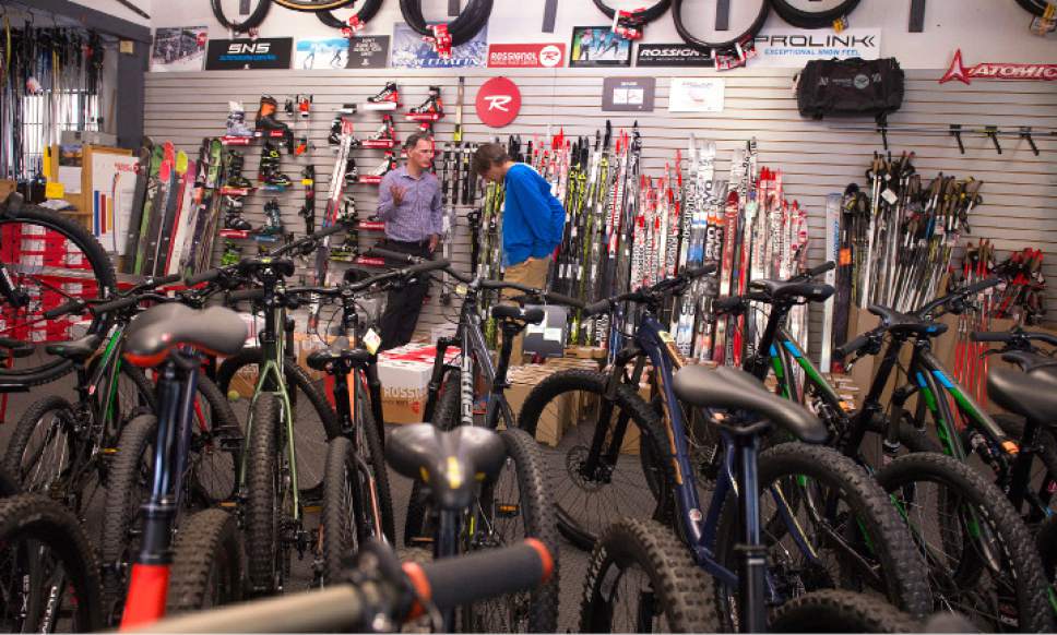 Leah Hogsten  |  The Salt Lake Tribune
Tim Metos, right, talks with a friend and customer on Wednesday, May 17, 2017.   After 32 years in business, Tim Metos is closing Wild Rose Sports, a small shop in the Avenues that provided custom mountain bikes and Nordic skiing products.
