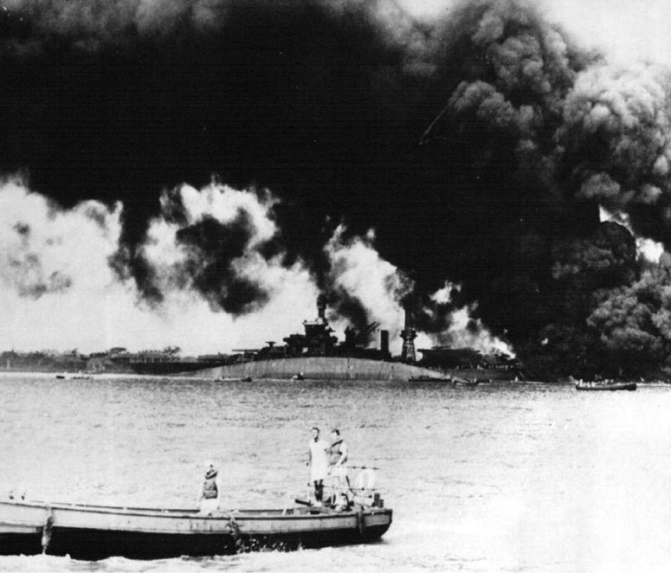 Tribune file photo
The USS Oklahoma rests capsized as smoke rises from the USS Maryland shortly after the Japanese attack on Pearl Harbor  Dec. 7, 1941. The U.S. military confirmed Friday that Navy Musician 1st Class Elliot Larson of Utah died when the Oklahoma was sunk.