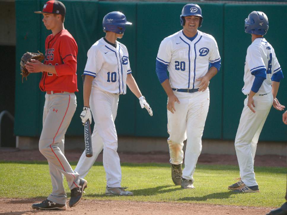 Leah Hogsten  |  The Salt Lake Tribune
Dixie's l-r Kaleb Leavitt, Wyatt Woodland and Kayler Yates celebrate their runs in the bottom of the 2nd inning on a hit by Tyson Miller. Dixie High School boys' baseball team defeated Park City High School 19-1 during their Class 3A baseball state semifinal at Brent Brown Ballpark, Friday, May 19, 2017.