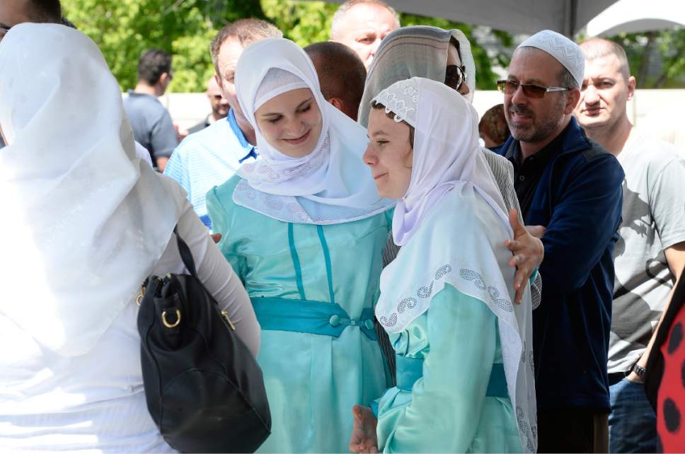 Scott Sommerdorf | The Salt Lake Tribune
Two young women, members of a choir that sang at the grand opening celebration of the Maryam Mosque, joke with each other Saturday as they wait in line for food. The day featured tours, music, authentic Bosnian food in celebration of the completion of the extensive remodeling of the mosque by the Islamic Society of Bosniaks in Utah.