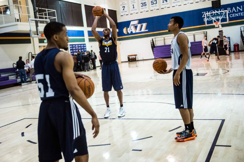 Chris Detrick  |  The Salt Lake Tribune
Mike Moser (71) Bryce Cotton (51) and Stephen Holt (64) shoot around during a workout at the Zions Bank Basketball Center Wednesday May 7, 2014.