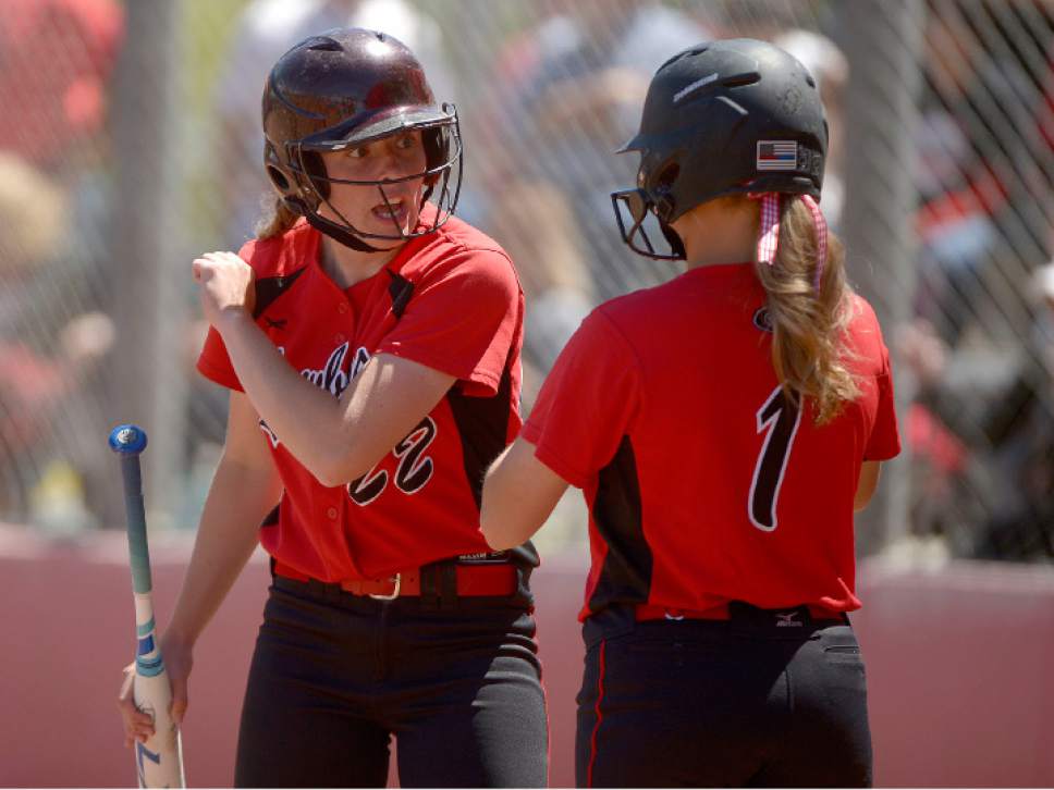 Leah Hogsten  |  The Salt Lake Tribune
After her scoring run, Grantsville's Brayle Crosman gives teammate Maddison Peterson some tips at the plate.  Grantsville High School girls' softball team defeated Bear River High School 7-4 to win the Class 3A Softball State Championship, Saturday, May 20, 2017.
