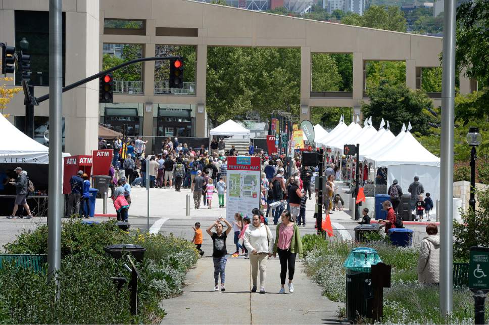Scott Sommerdorf | The Salt Lake Tribune
People walk between the Library and the City and County Building at the 32nd Living Traditions Festival at Library Square on Sunday.