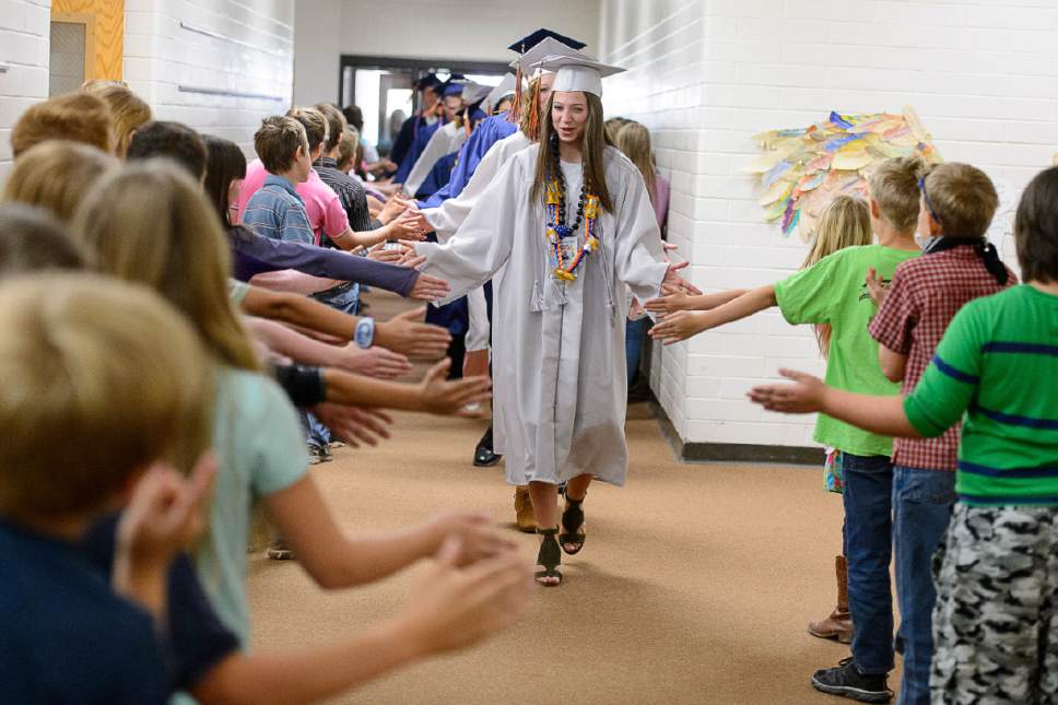 Trent Nelson  |  The Salt Lake Tribune
Water Canyon High School graduate Amy Barlow leads a procession of high-fives through Water Canyon Elementary prior to the high school's graduation ceremony in Hildale, Monday May 22, 2017. Two years ago the school had one graduate, this year twenty-five.