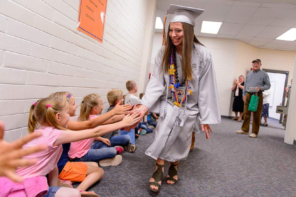 Trent Nelson  |  The Salt Lake Tribune
Water Canyon High School graduate Amy Barlow leads a procession of high-fives through Water Canyon Elementary prior to the high school's graduation ceremony in Hildale, Monday May 22, 2017. Two years ago the school had one graduate, this year twenty-five.