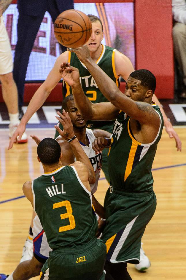 Trent Nelson  |  The Salt Lake Tribune
LA Clippers guard Chris Paul (3) passes through the arms of Utah Jazz guard George Hill (3) and Utah Jazz forward Derrick Favors (15) as the Utah Jazz face the Los Angeles Clippers in Game 7 at STAPLES Center in Los Angeles, California, Sunday April 30, 2017.