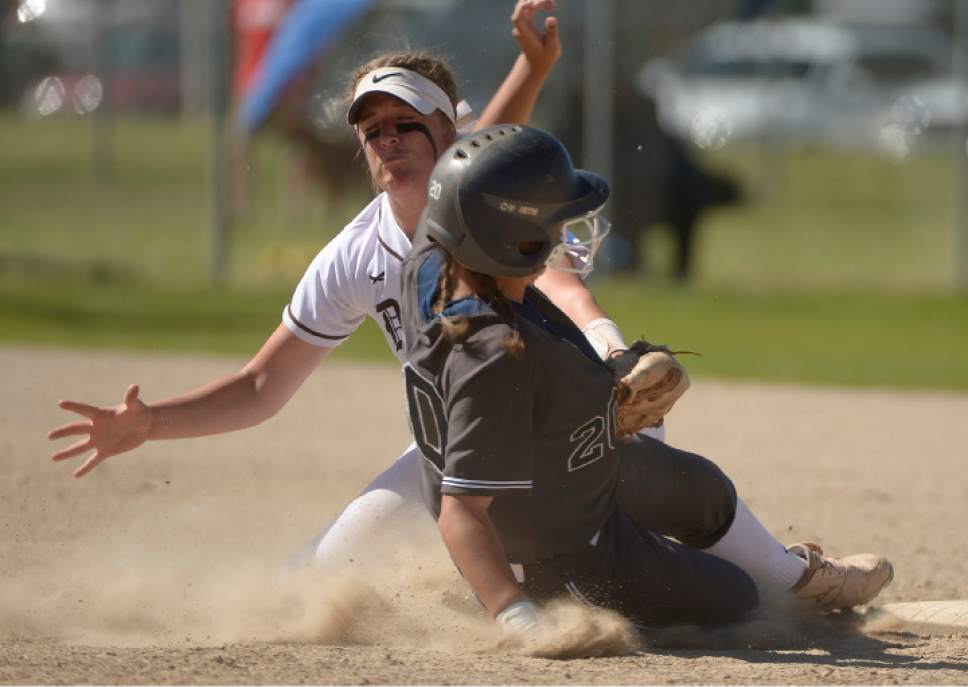 Leah Hogsten  |  The Salt Lake Tribune
Copper Hills' Celeste Davies slides safely into second when Davis' Carley Croshaw makes a tag without the ball. Copper Hills High School girls' softball team defeated Davis High School 5-4 in nine innings to win the quarterfinal game in the Class 5A Softball State playoff tournament at Valley Softball Complex, Tuesday, May 23, 2017.